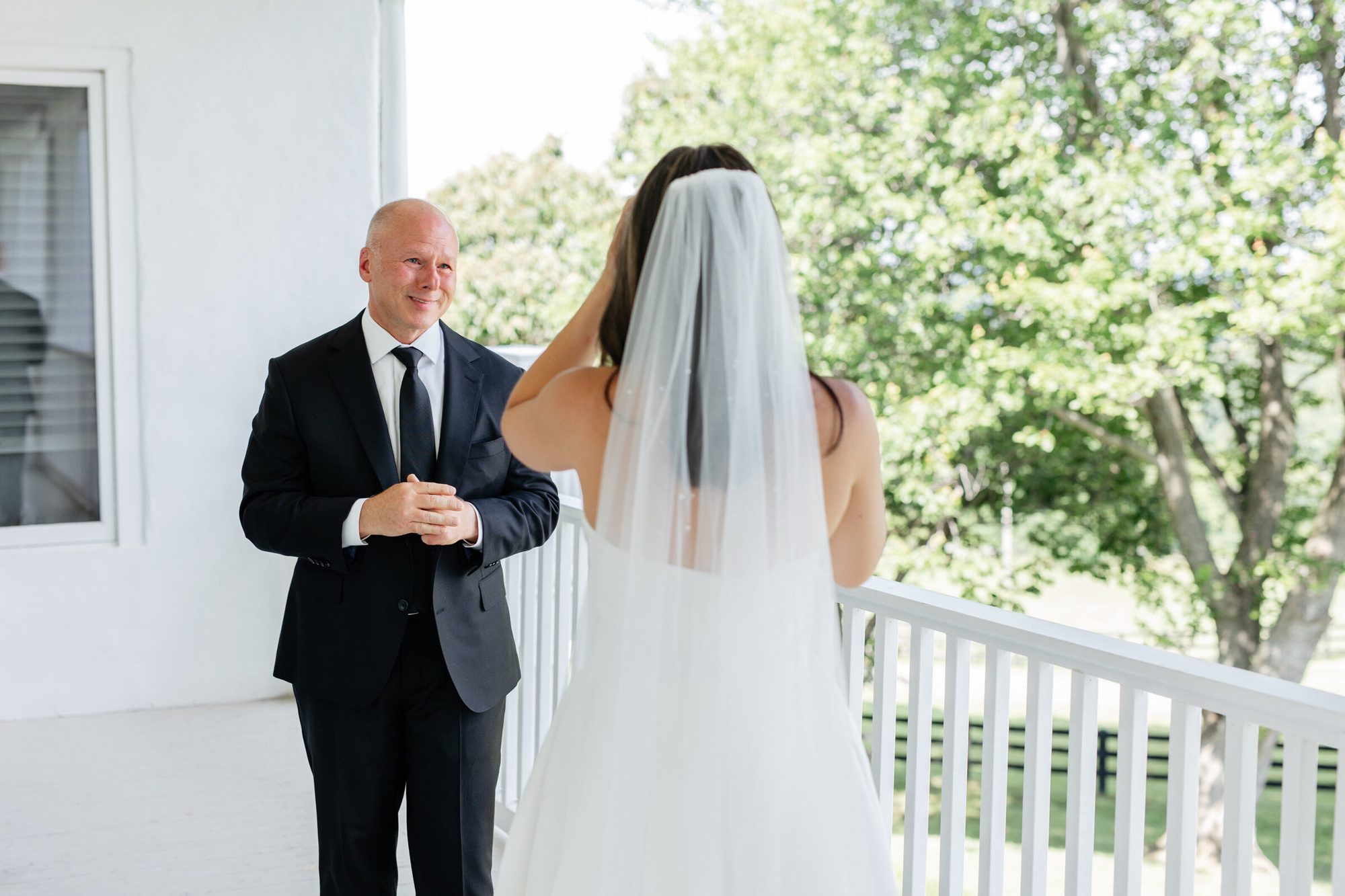 Bride facing her father on the porch before his first look at The View at Bluemont