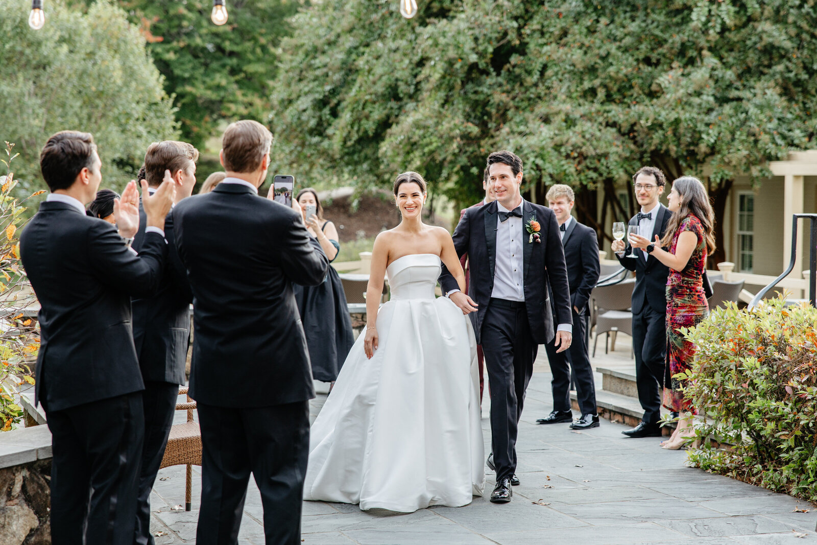 Newlyweds walking back up the aisle as guests applaud at Boars Head Resort