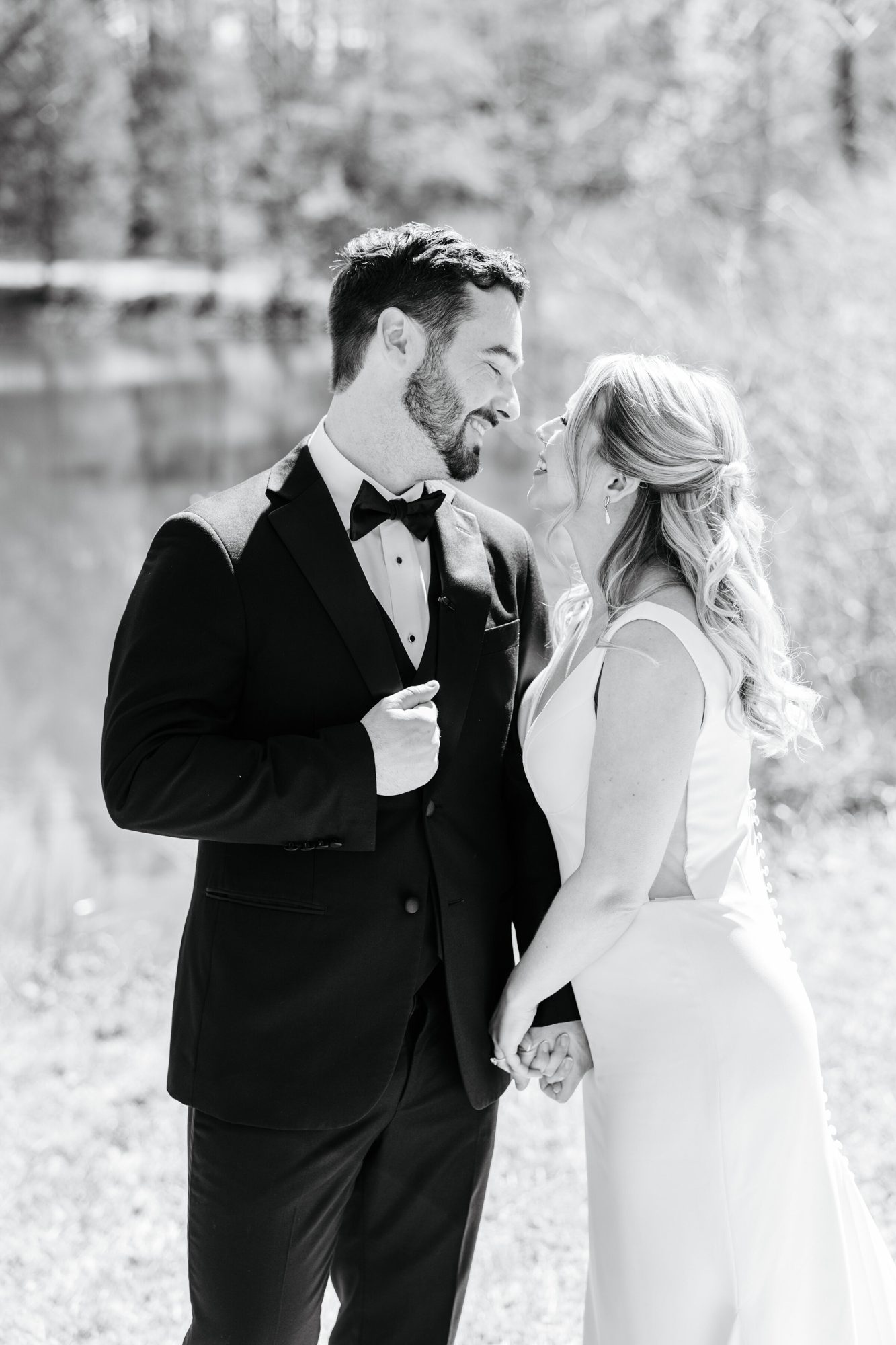 Black-and-white portrait of the couple smiling at each other at Historic Whitewood