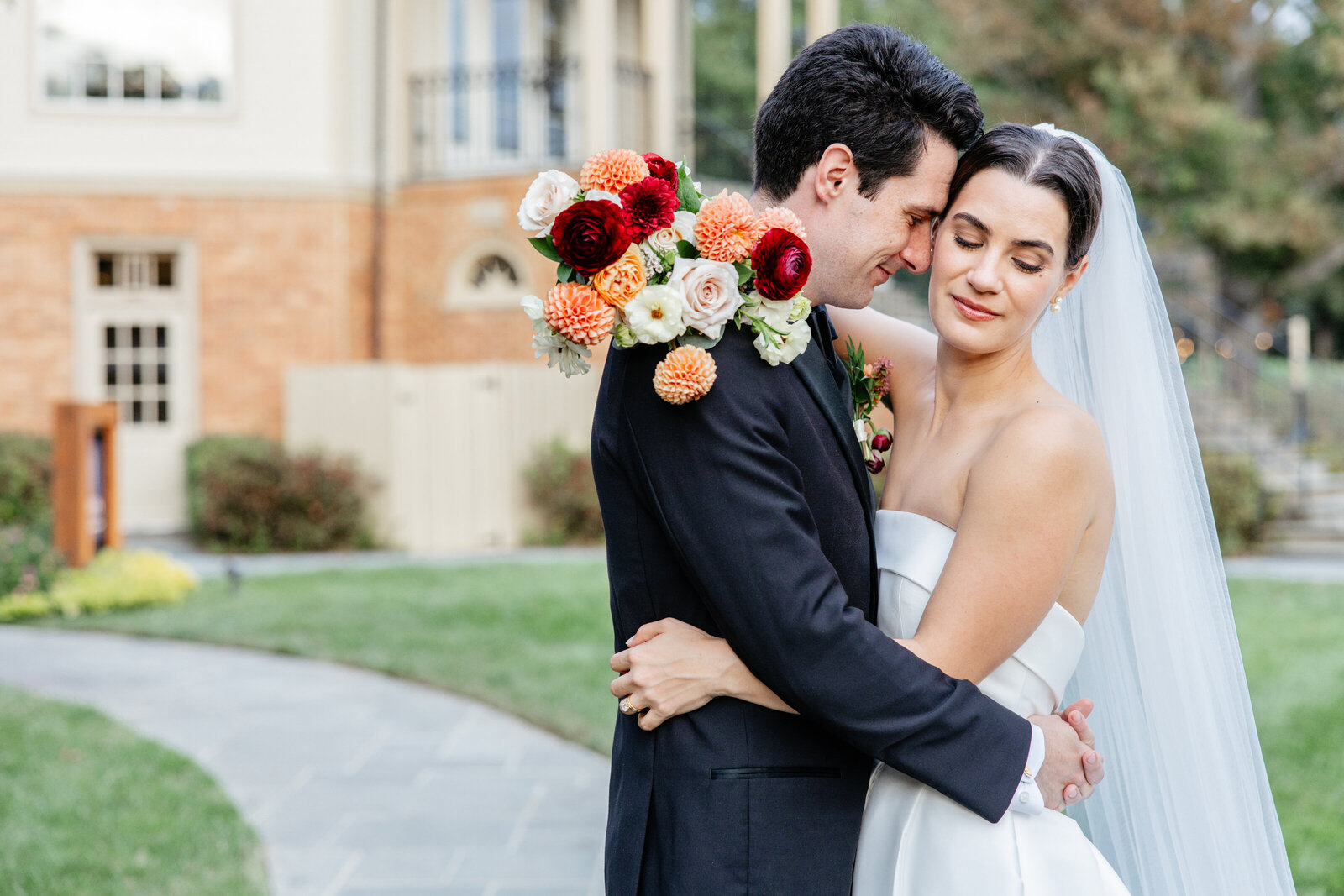 Couple embracing with her bouquet in the garden at Boars Head Resort
