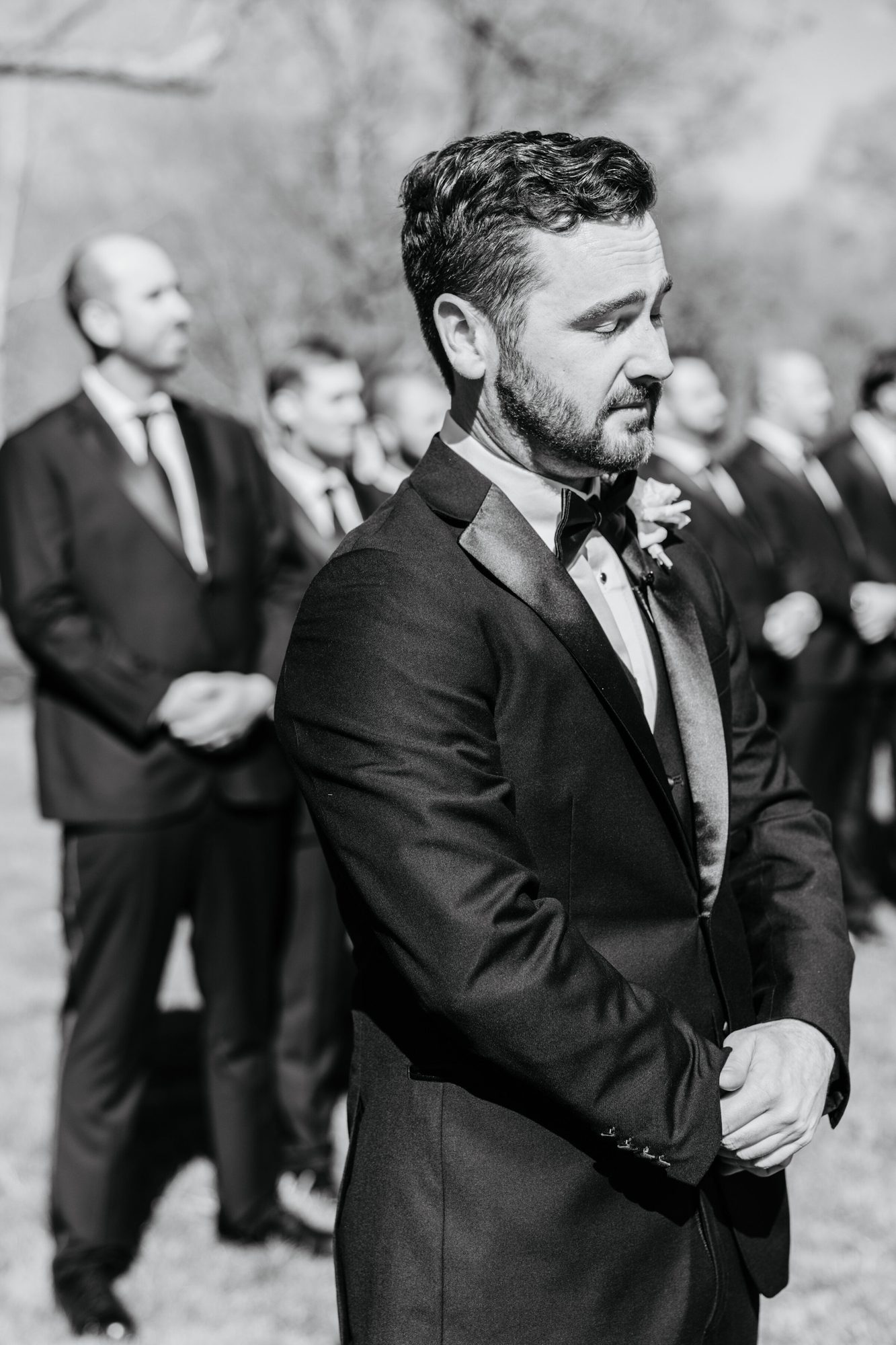 Black-and-white photo of the groom waiting at the ceremony at Historic Whitewood