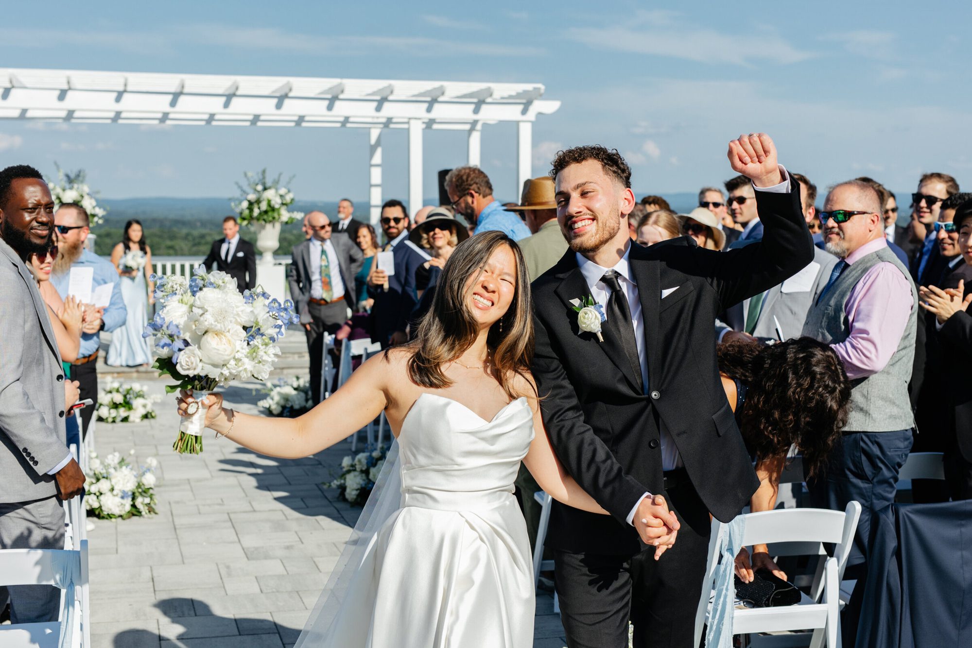 Couple celebrating as they walk back up the aisle at The View at Bluemont