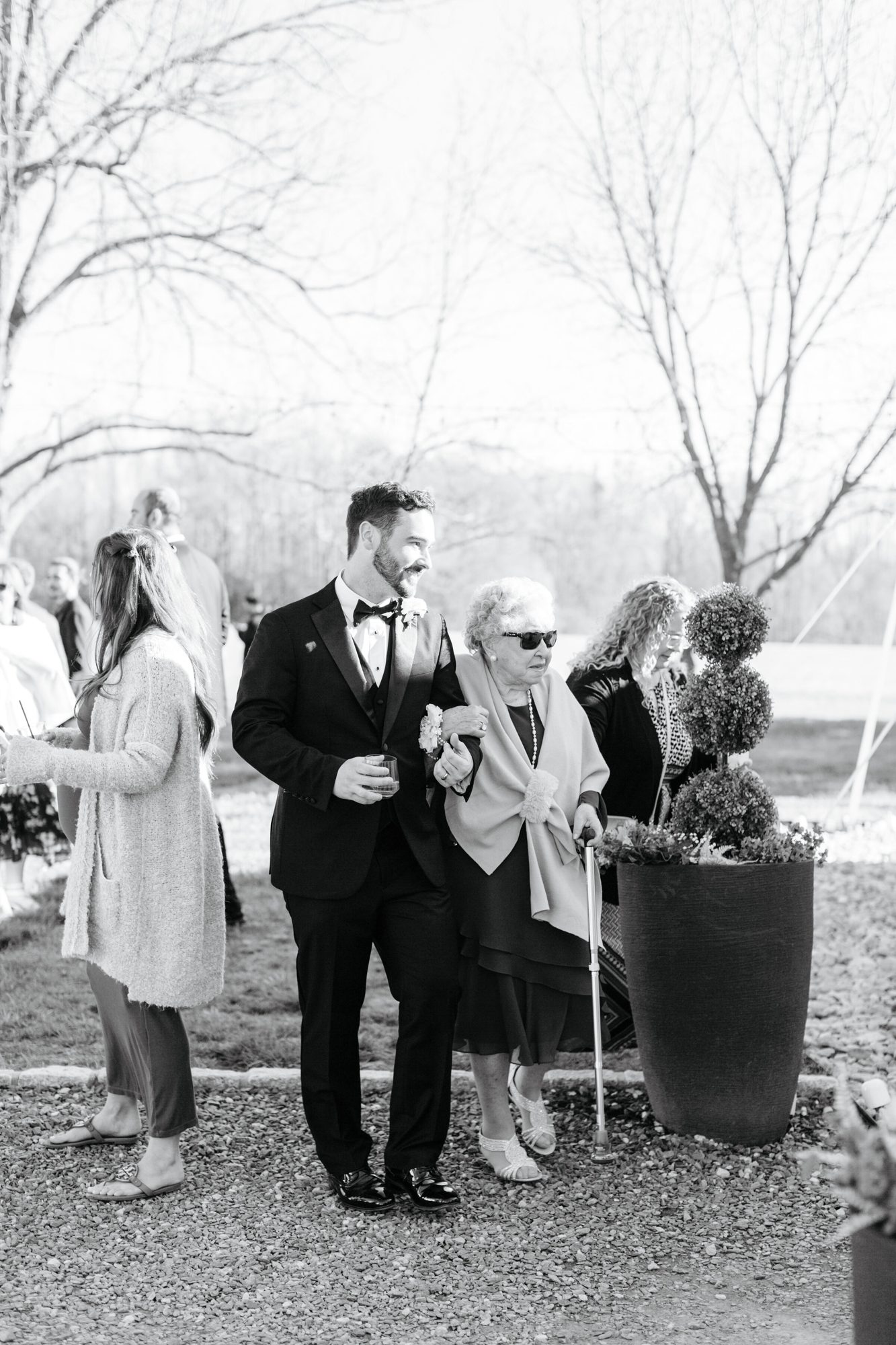 Black-and-white photo of the groom greeting guests at Historic Whitewood
