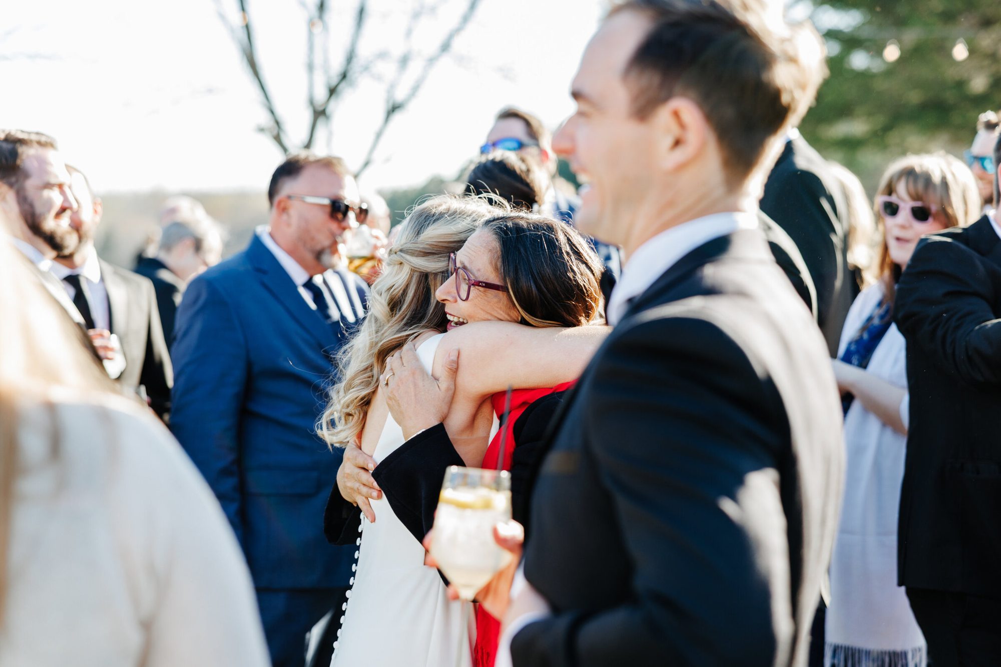 Bride hugging guests during cocktail hour at Historic Whitewood