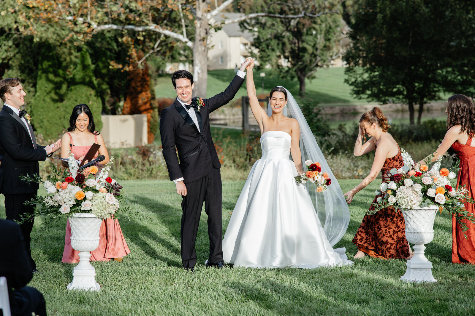 Couple celebrating with arms raised after the ceremony at Boars Head Resort
