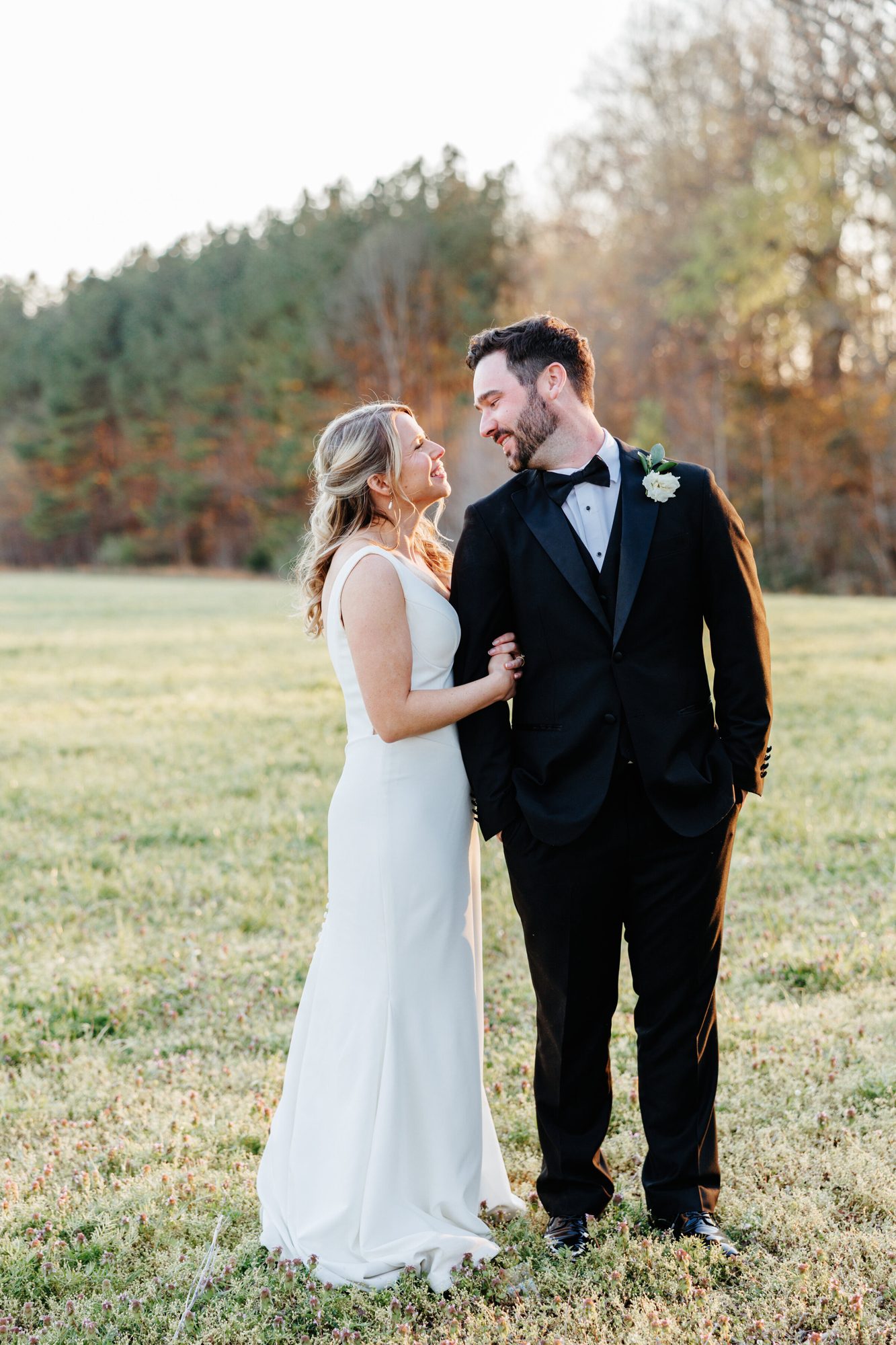 Couple standing in a field at sunset at Historic Whitewood