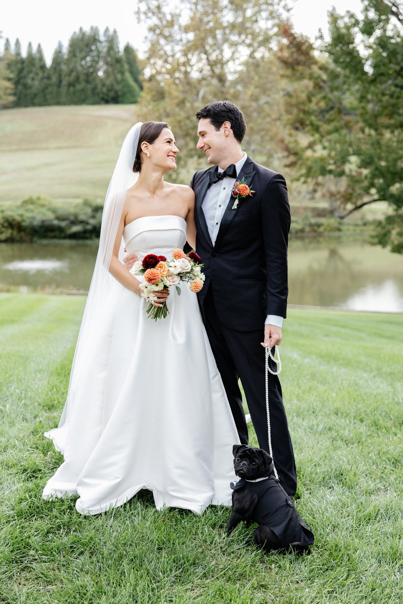 Couple standing on the lawn with their dog at Boars Head Resort