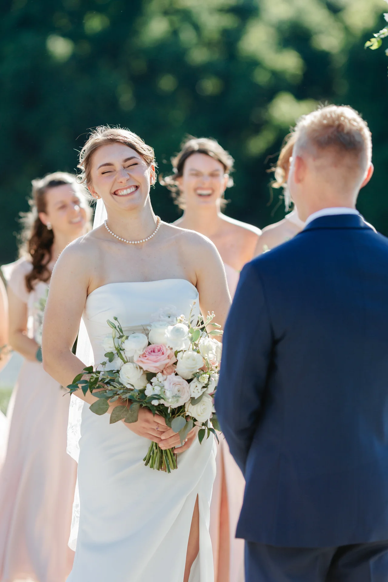 Bride smiling at her groom during an outdoor ceremony