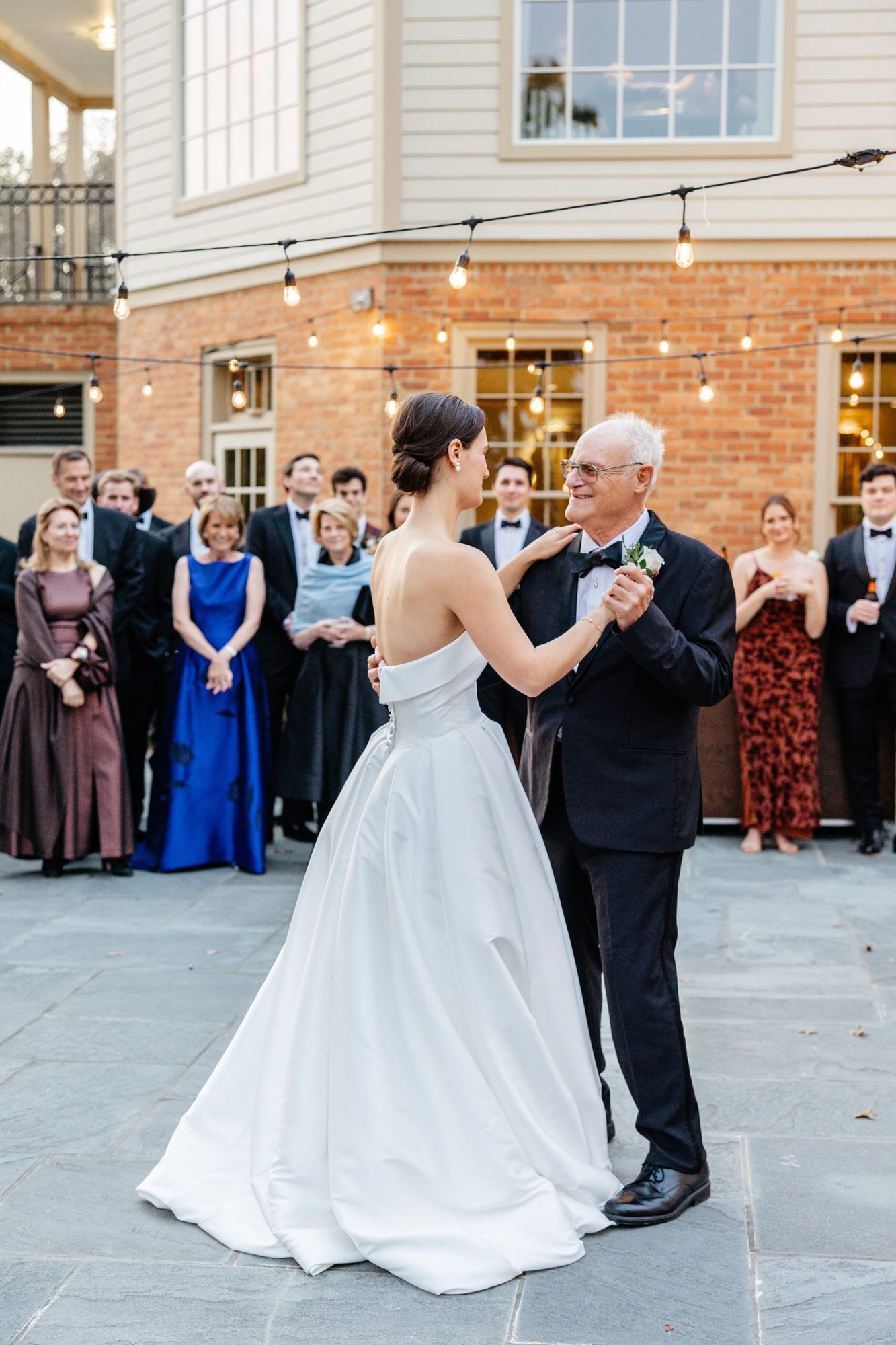 Bride dancing with her father on the patio at Boars Head Resort