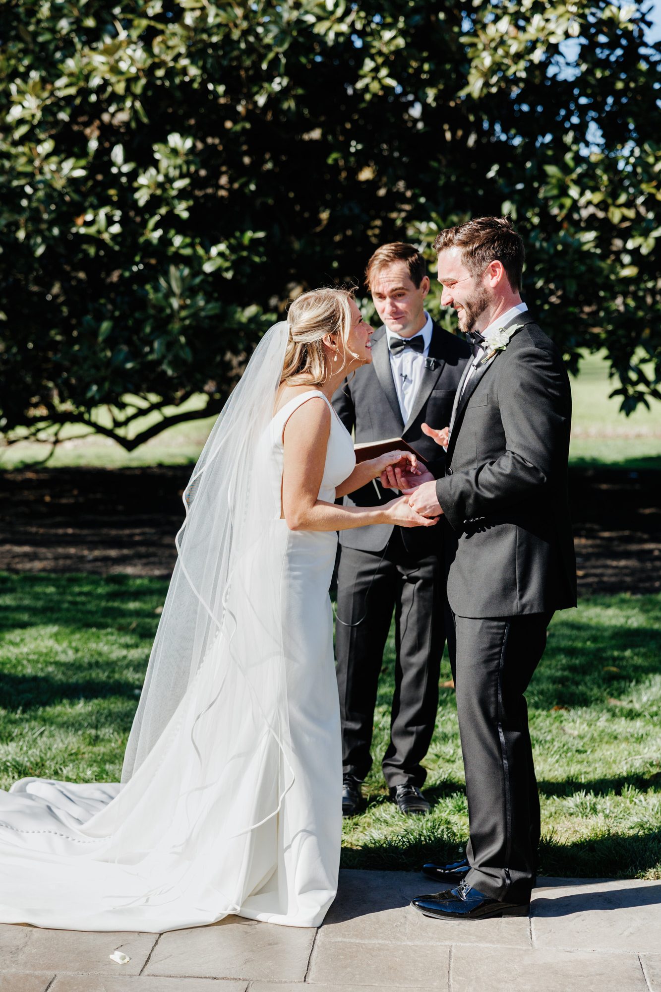 Couple during the ceremony under a large tree at Historic Whitewood