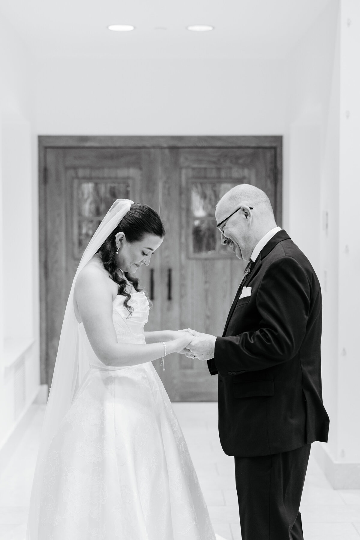 Black-and-white first look between a bride and her father