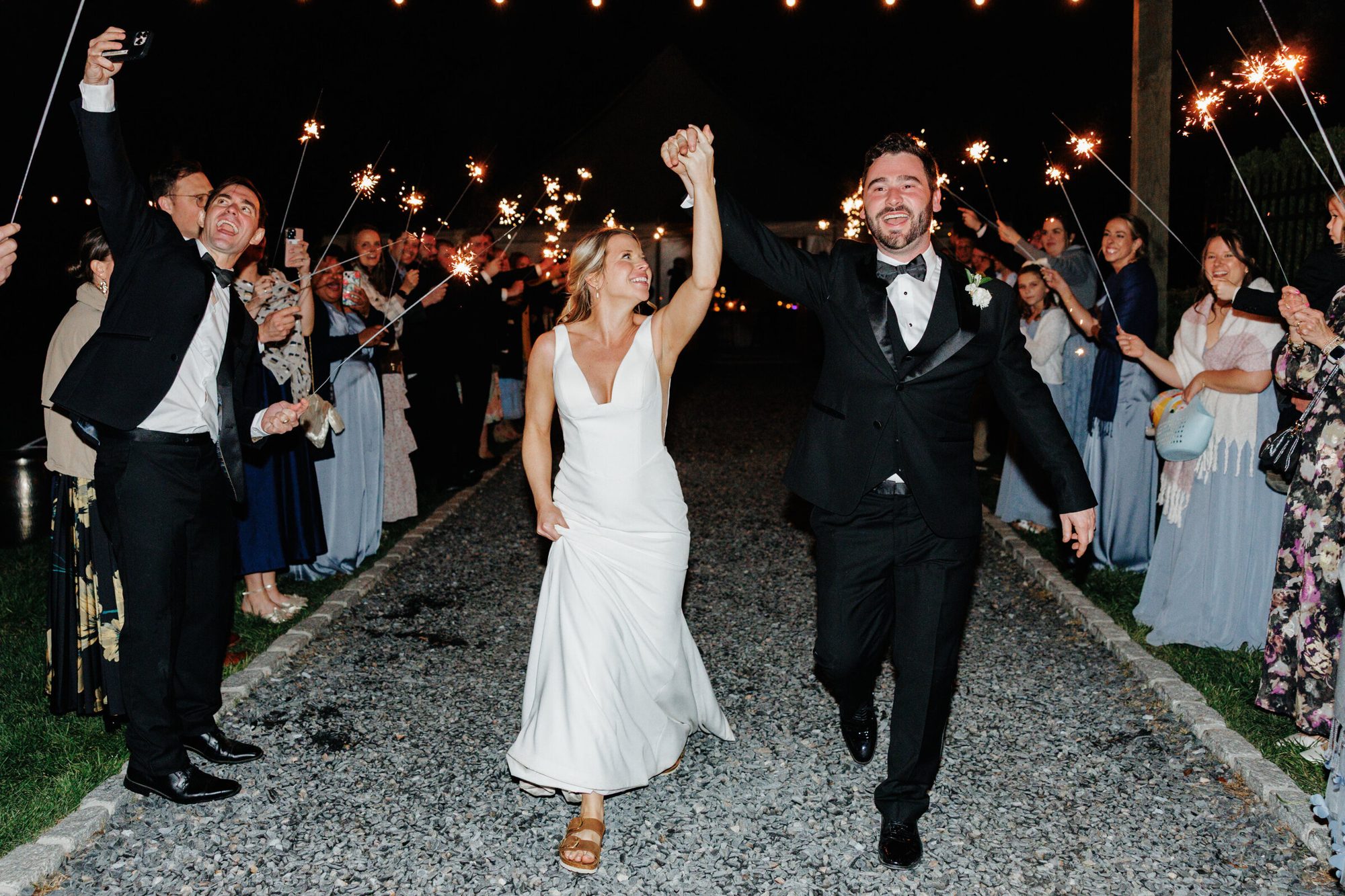 Couple celebrating during their nighttime exit at Historic Whitewood