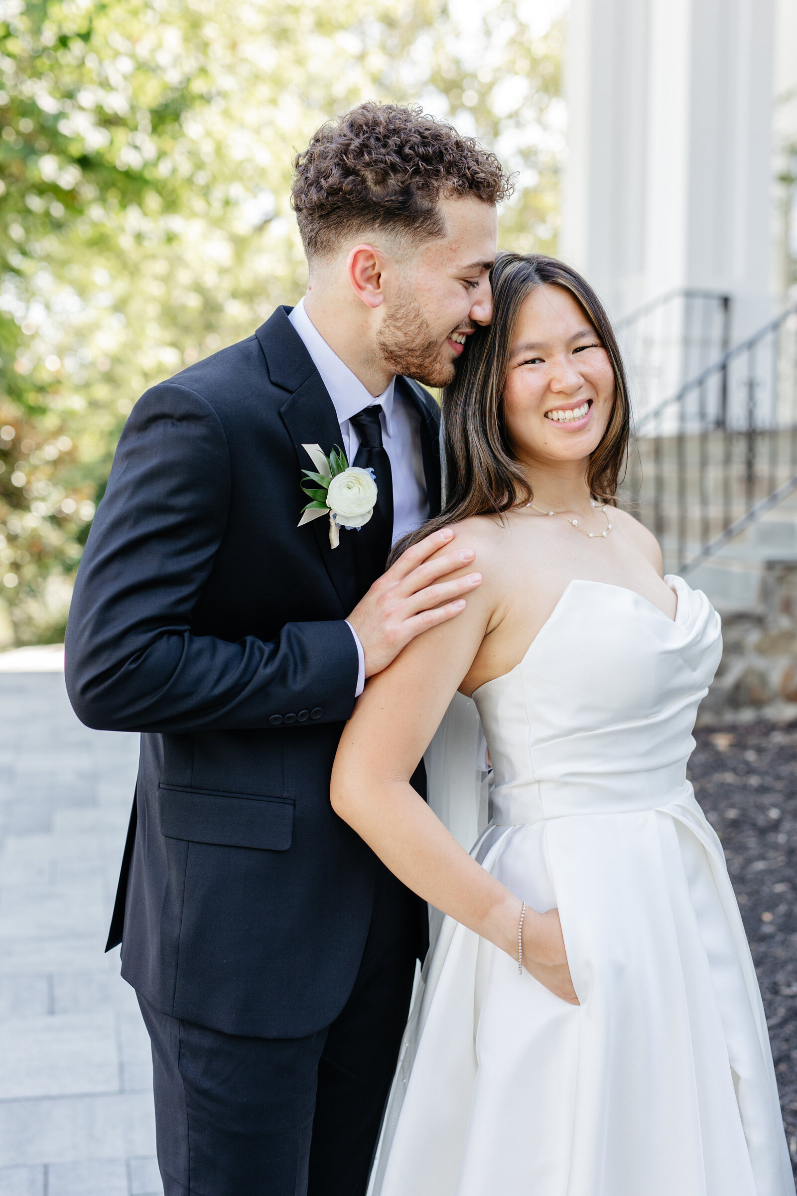Groom embracing the bride from behind at The View at Bluemont