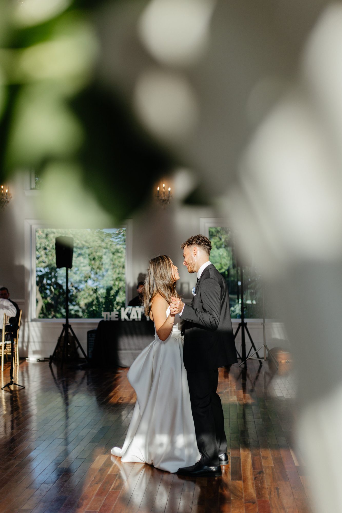 First dance seen through greenery at The View at Bluemont