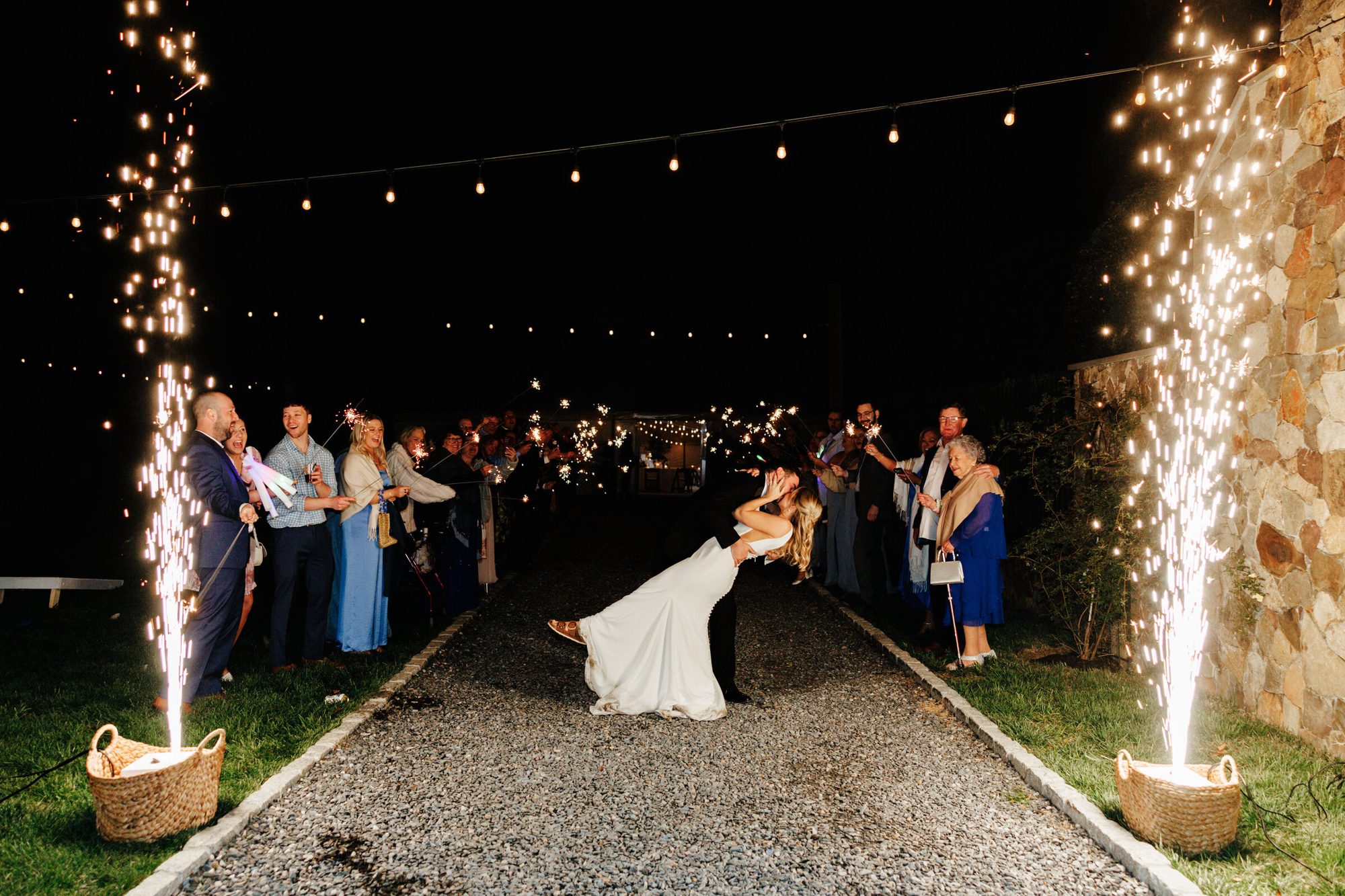 Couple kissing between sparkler fountains at their exit at Historic Whitewood