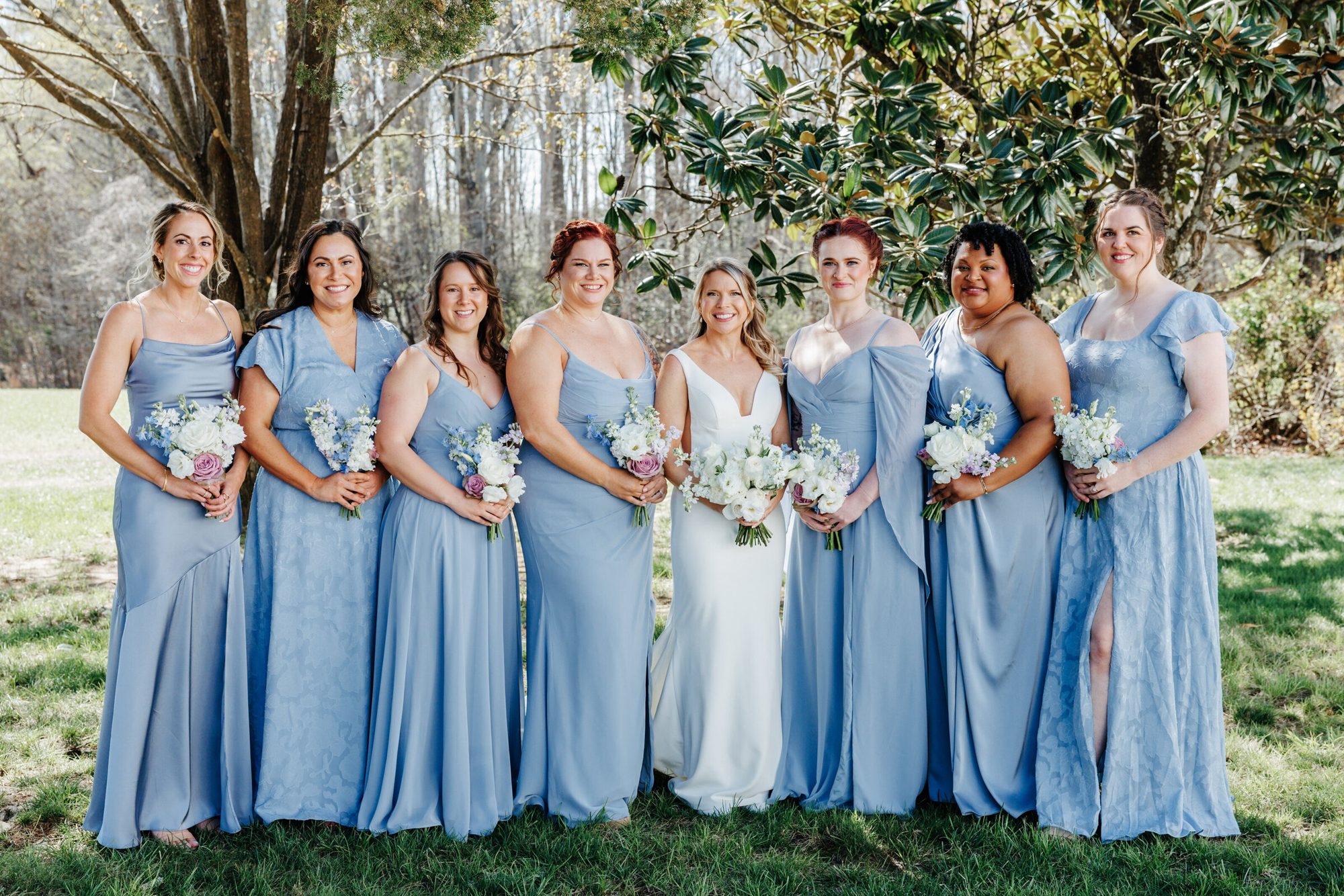 Bride with her bridesmaids in light blue dresses at Historic Whitewood