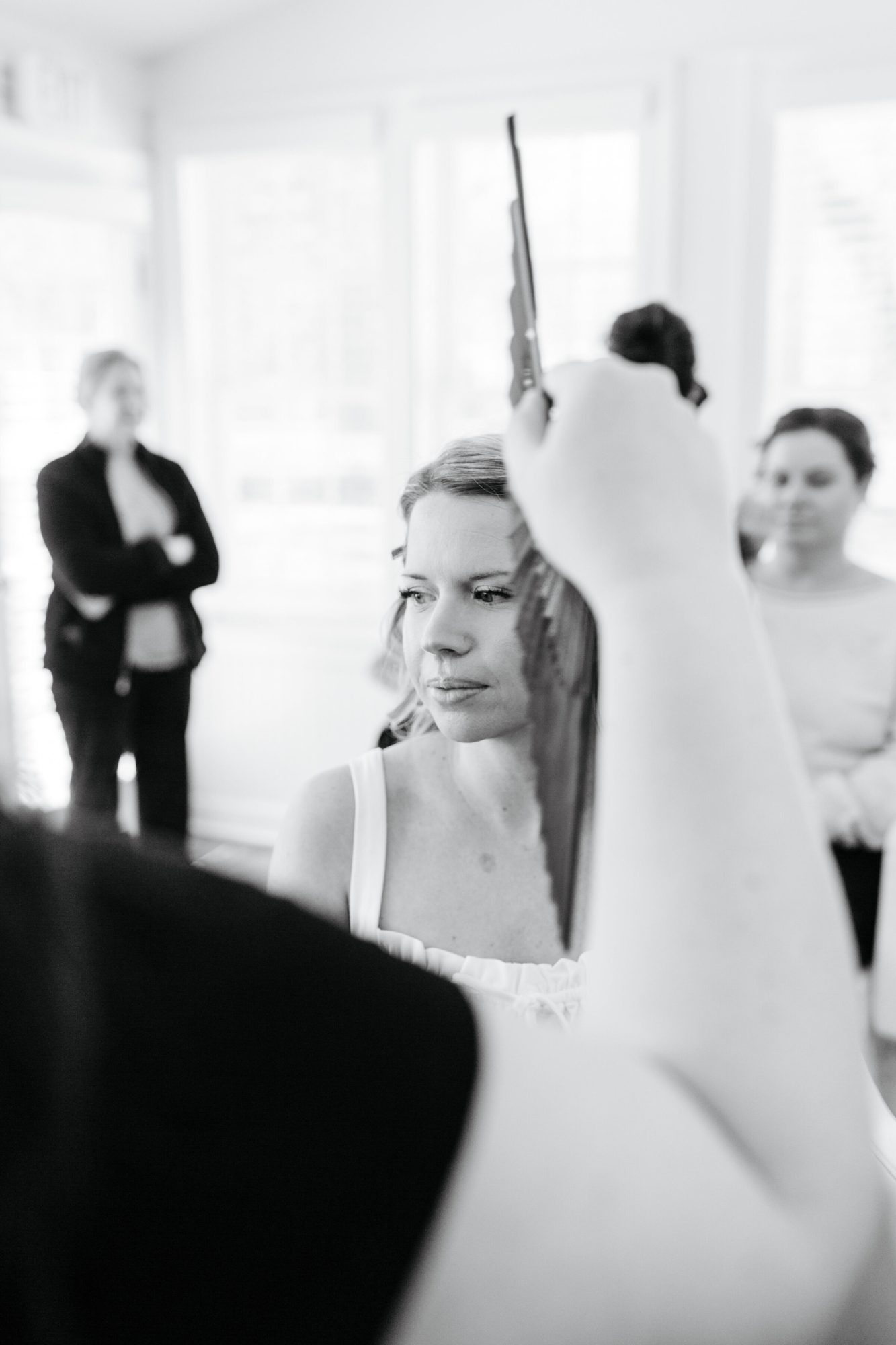 Black-and-white photo of the bride getting ready at Historic Whitewood