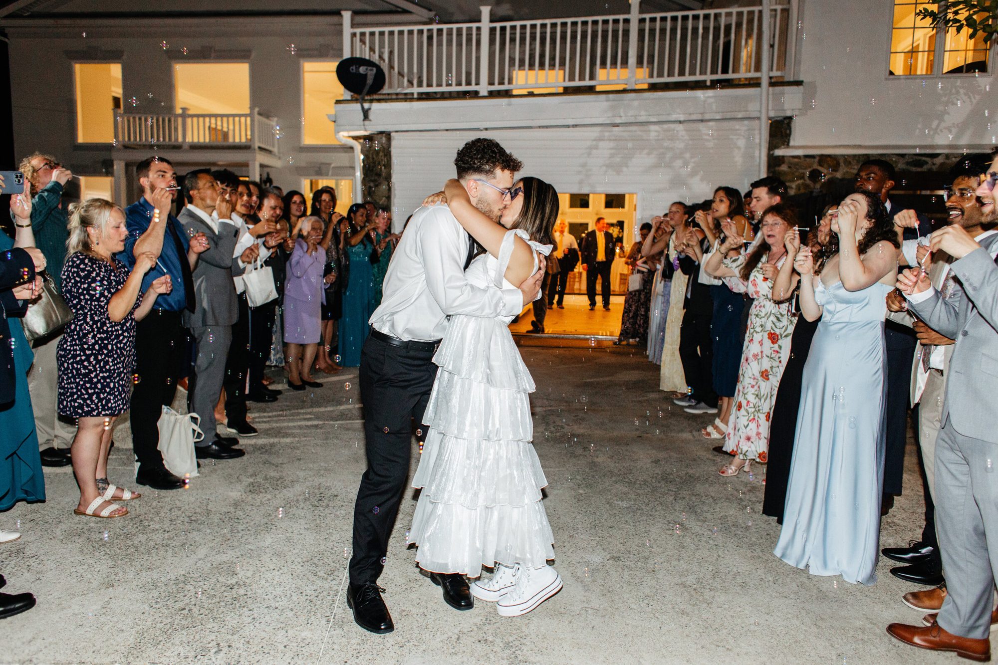 Couple kissing during their sparkler-lined exit at The View at Bluemont