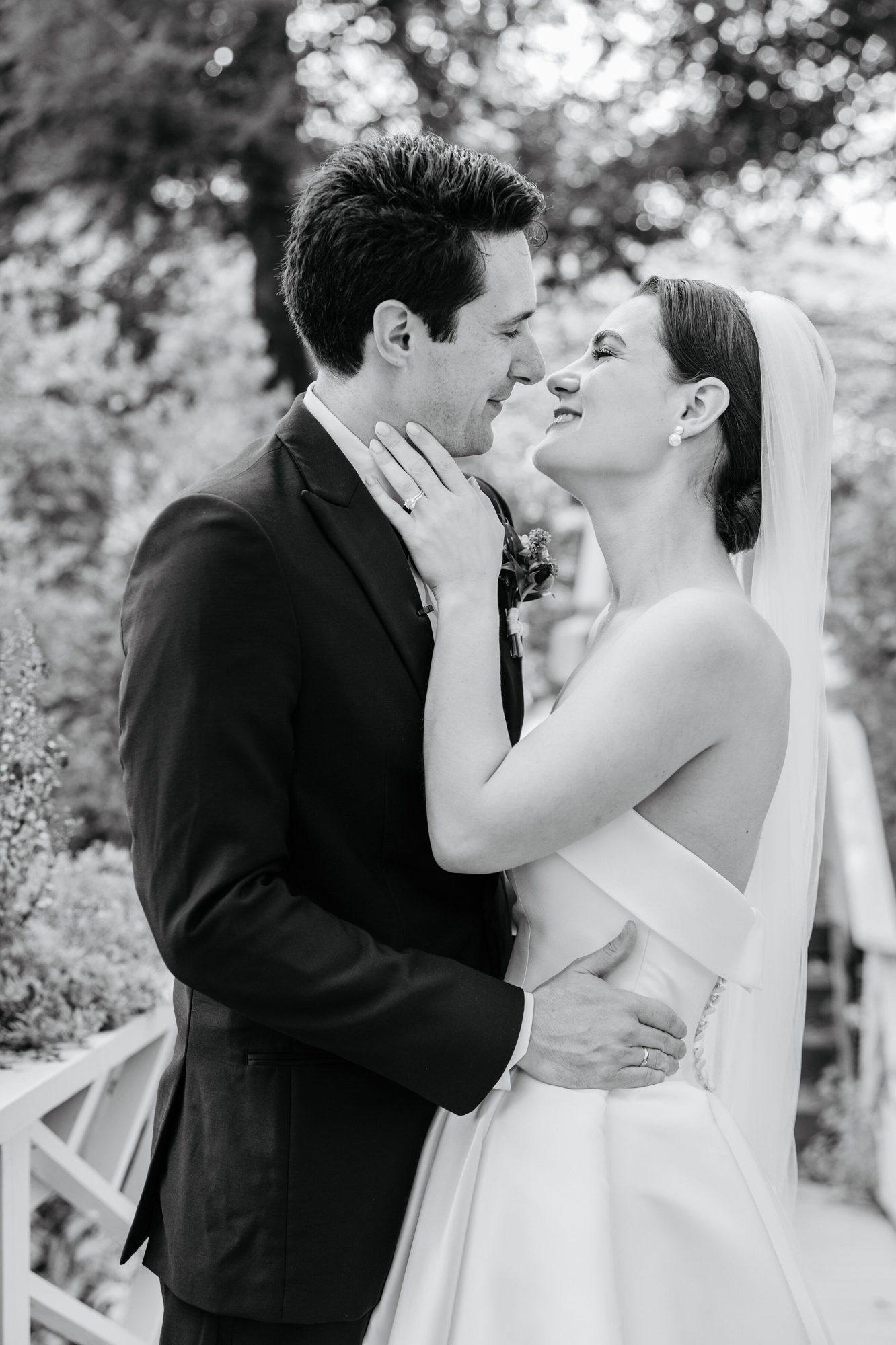 Black-and-white portrait of the groom touching the bride’s face at Boars Head Resort