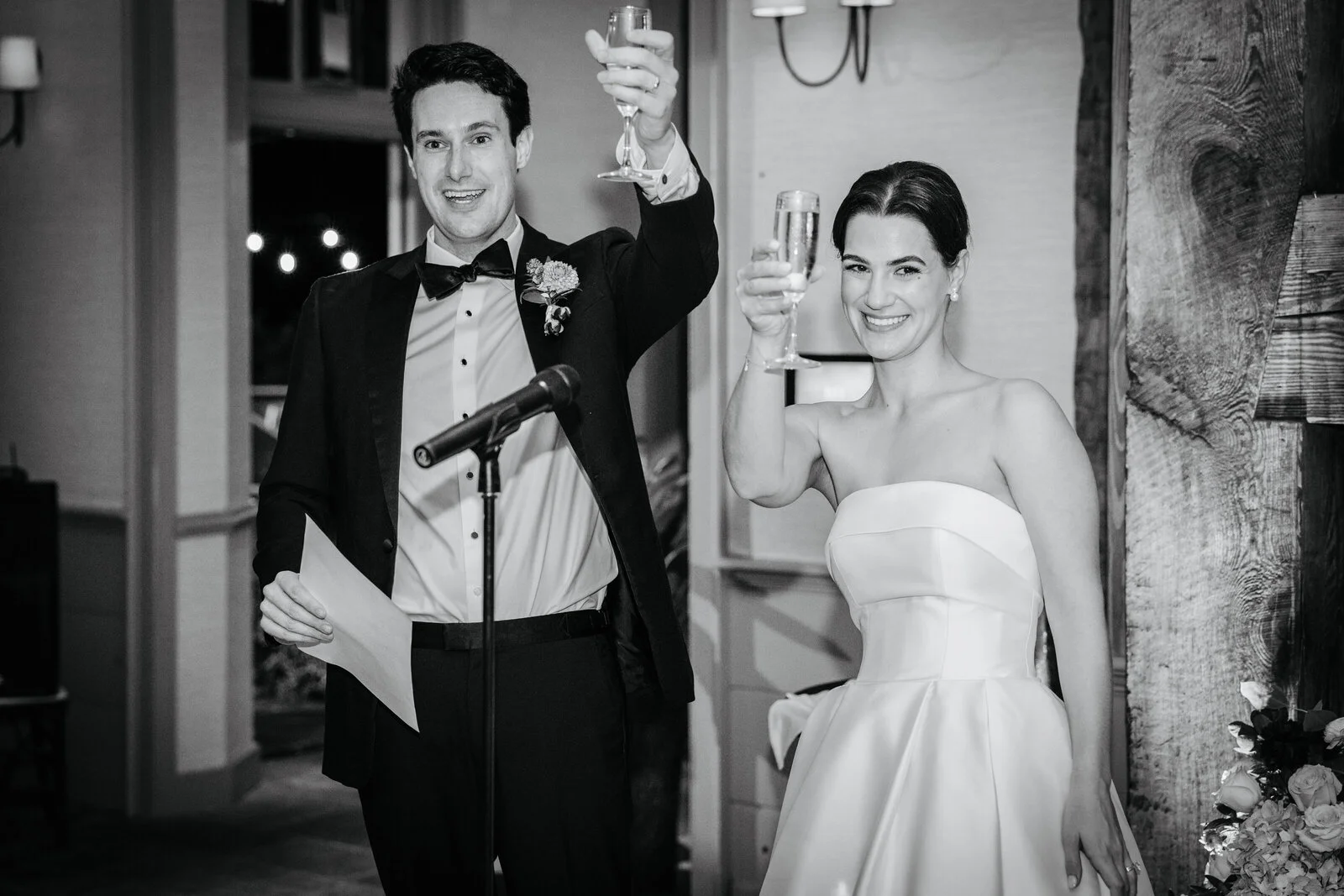 Bride and groom raising glasses in a toast