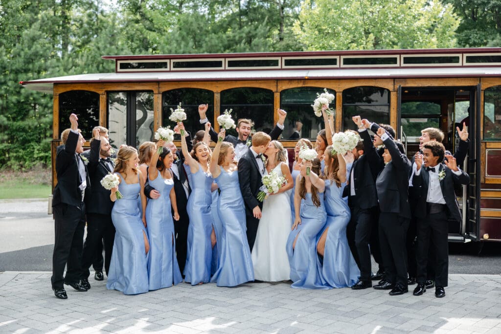 A couple reviewing their wedding gallery on a laptop with an external drive nearby, highlighting wedding photo backup storage.