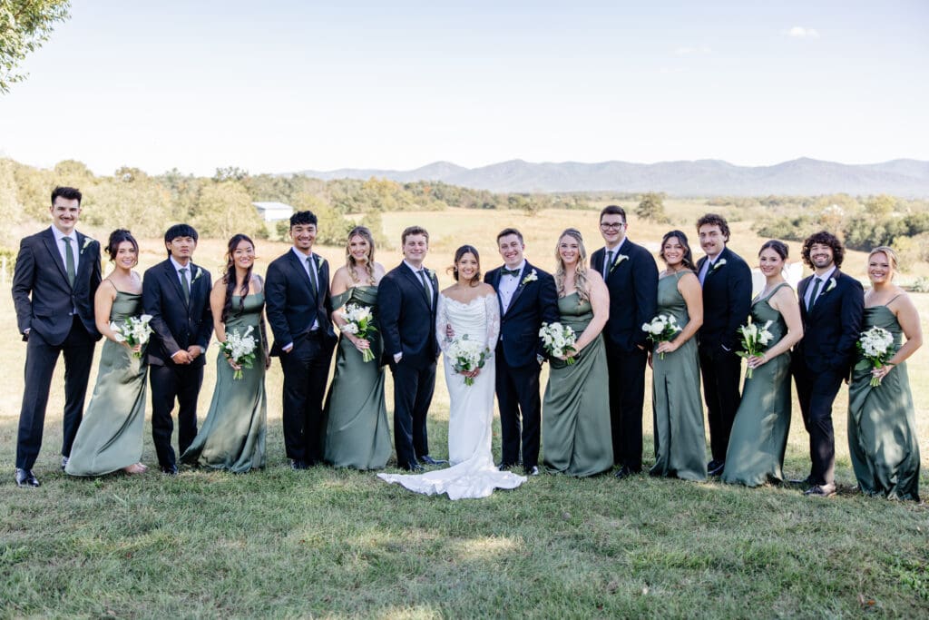 A bridal party laughing together on a tree-lined path, showcasing creative bridal party photo ideas at a Virginia wedding.