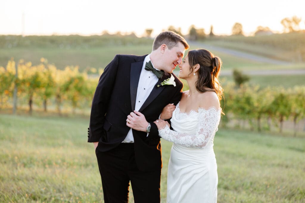 A bride and groom walking through golden light during their golden hour wedding portraits at a Virginia venue.