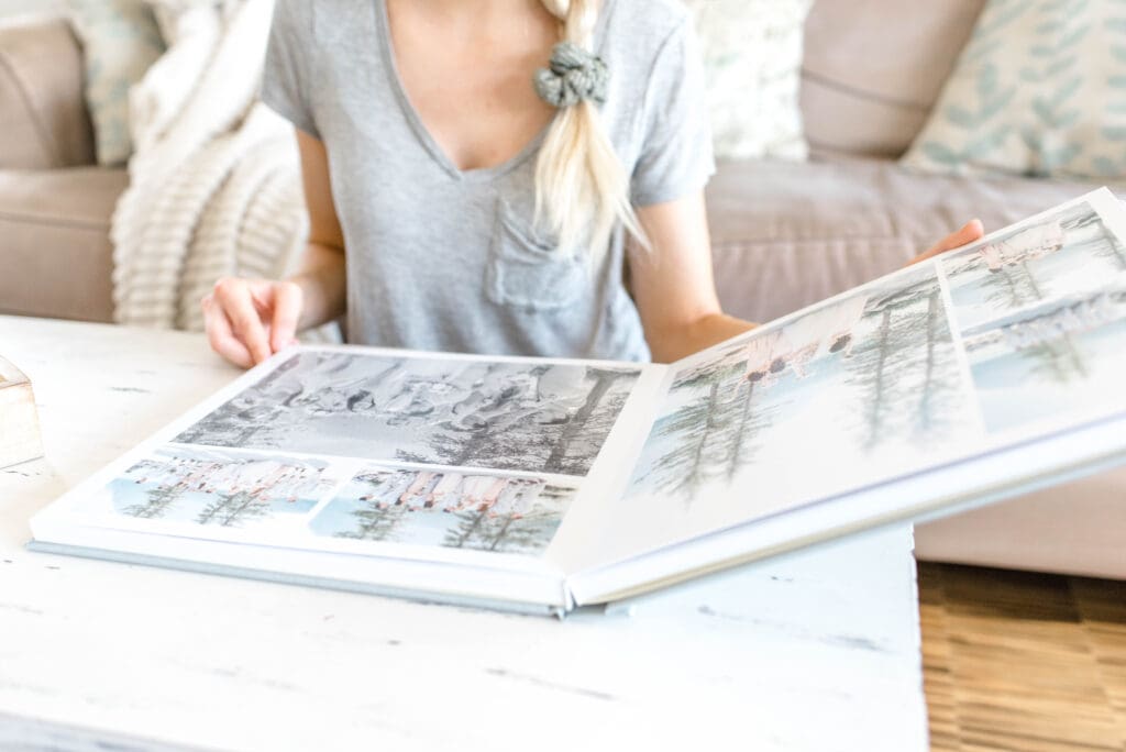 An open wedding album on a coffee table displaying printed portraits, showcasing beautiful wedding album printing options.