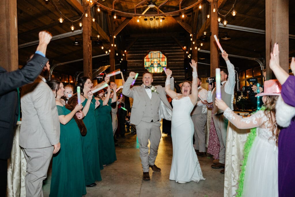 A couple running through a sparkler tunnel at the end of the night, inspired by creative wedding send off ideas.

