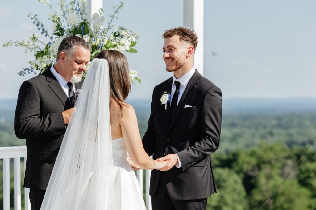Two photographers capturing different angles during a ceremony, demonstrating the second shooter wedding benefits couples love.