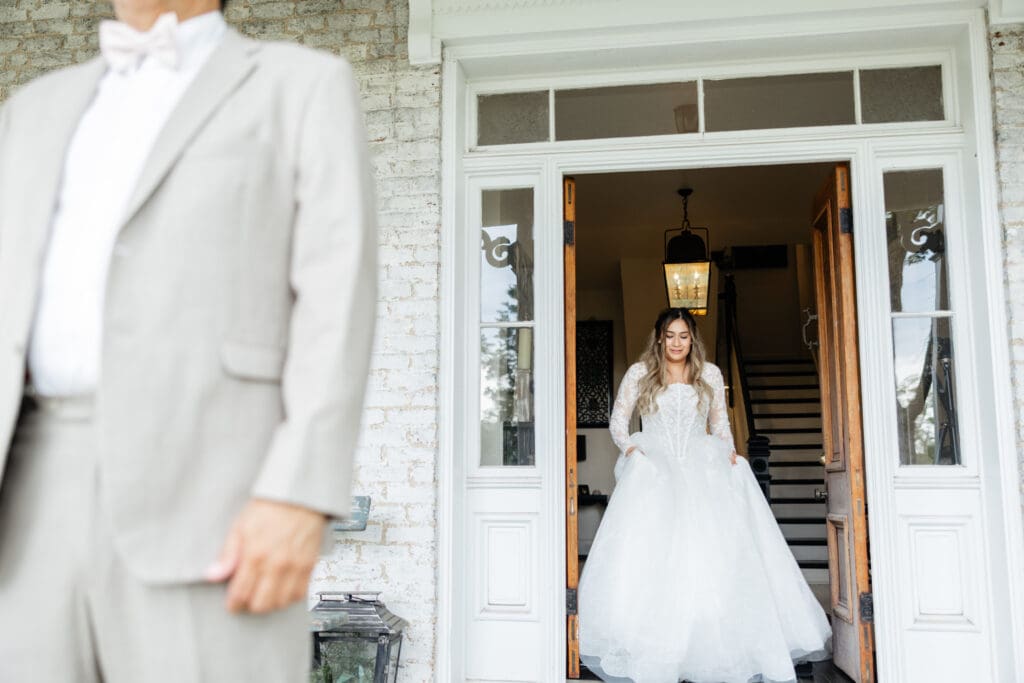 A groom turning around to see his bride for the first time during first look wedding photos at a Virginia venue.