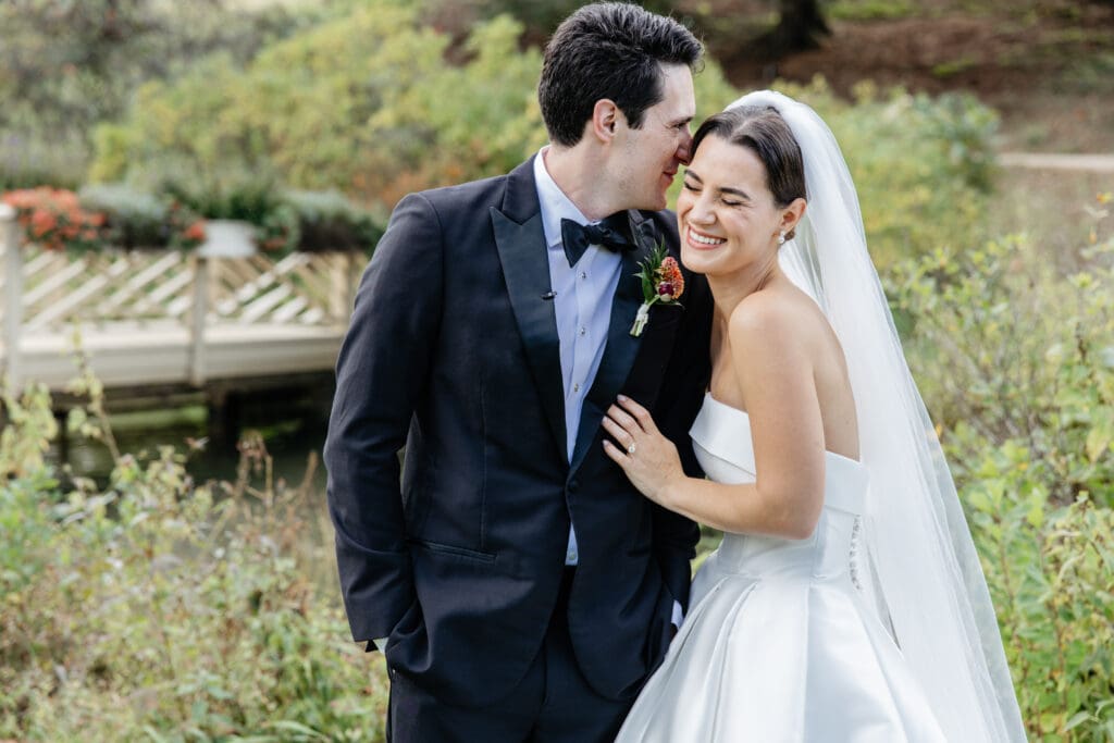 A bride and groom walking through golden hour light, showcasing how wedding day timeline tips lead to gorgeous portraits.