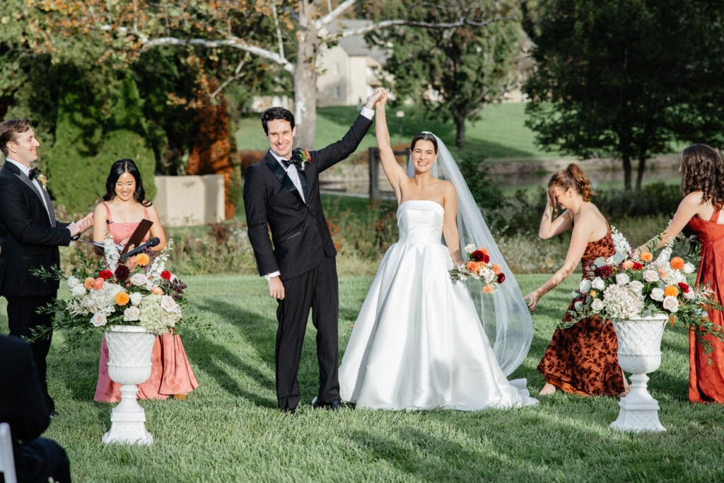 A couple standing in front of a Virginia vineyard at sunset, highlighting one of many stunning Virginia wedding venue ideas.